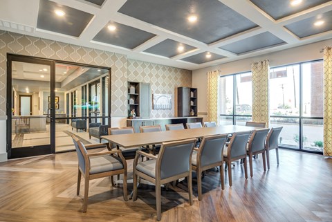 A conference room with a long table and chairs.