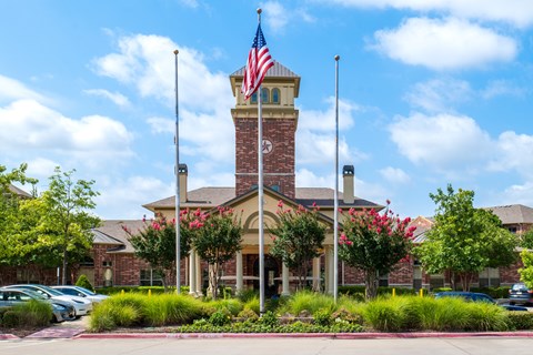 A building with a flag on top and a clock tower.