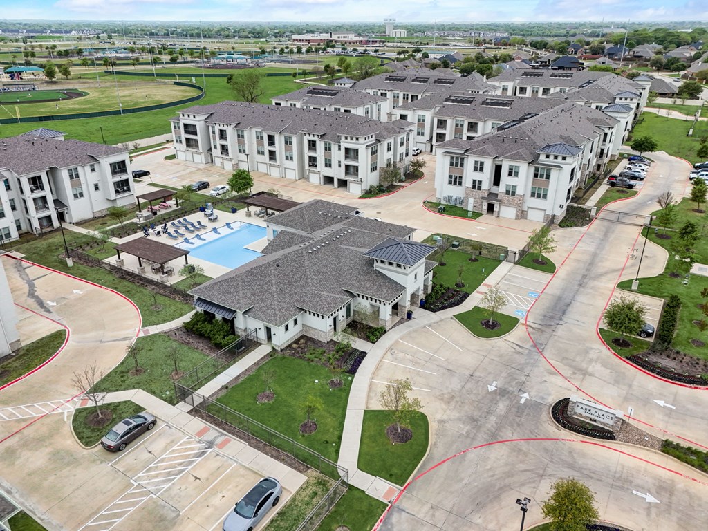 an aerial view of a group of houses and a swimming pool