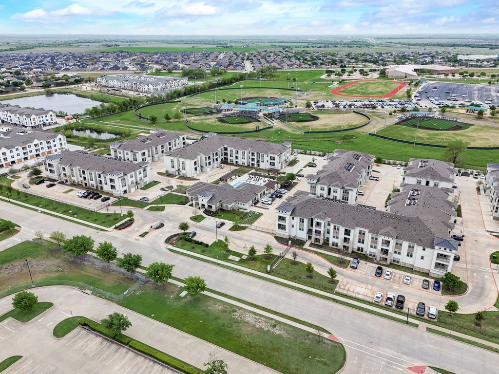 an aerial view of a community with houses and a parking lot