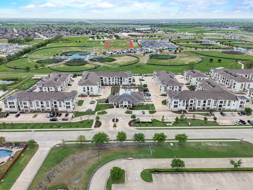an aerial view of a neighborhood with houses and a parking lot