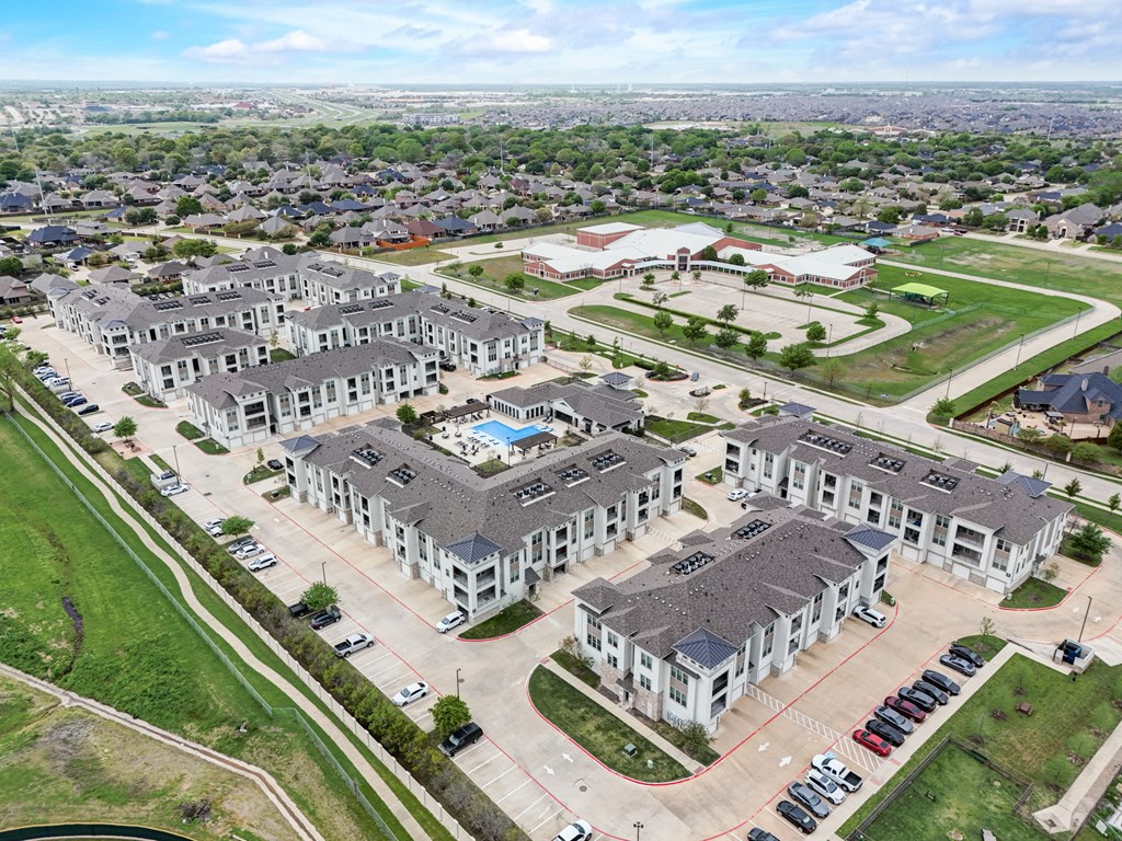 an aerial view of a group of houses and a parking lot