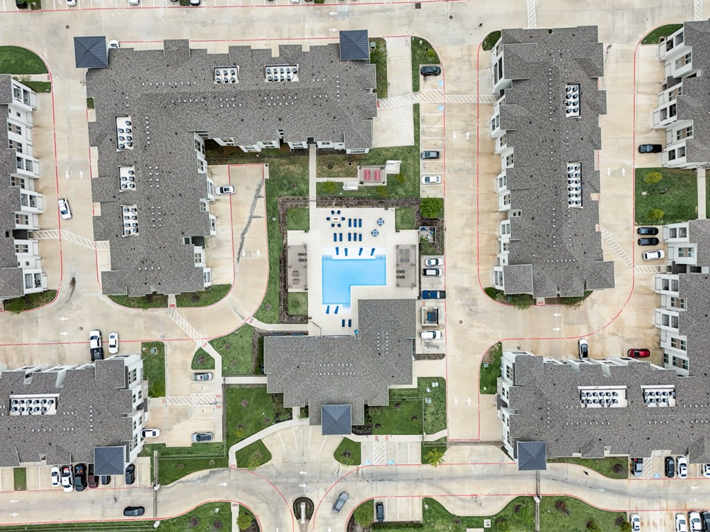 an aerial view of a neighborhood with houses and a pool