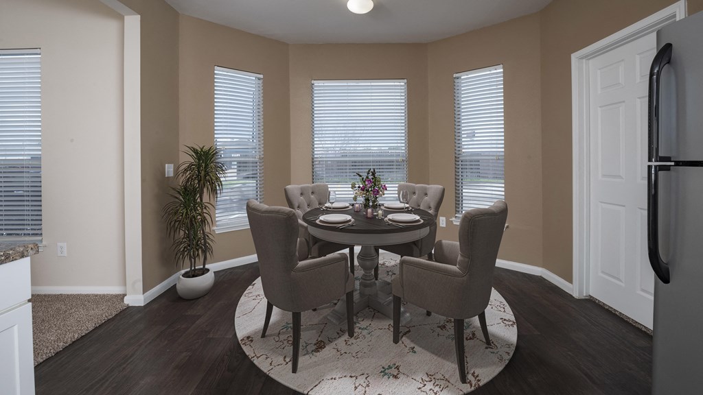 a dining room with a table and chairs