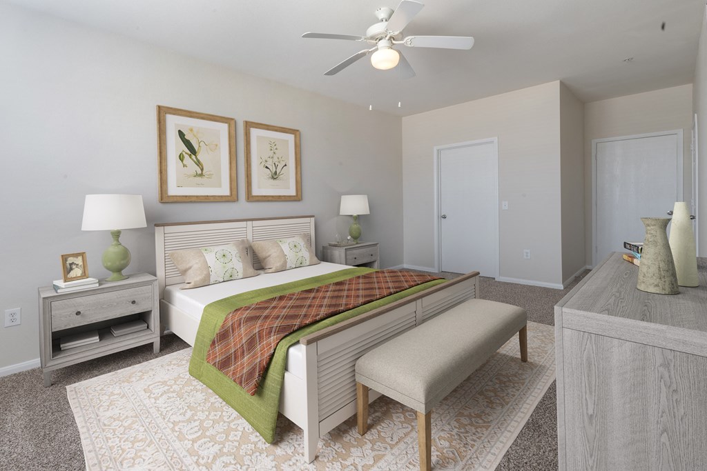 a bedroom with a bed and a ceiling fan