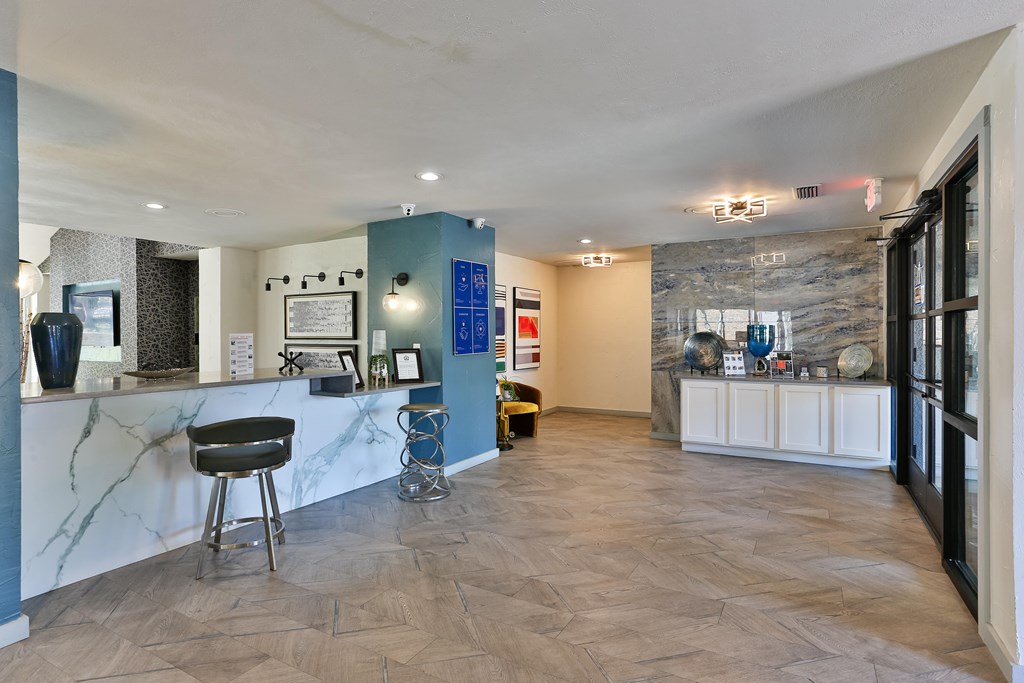 A spacious room with a marble counter and a black chair.