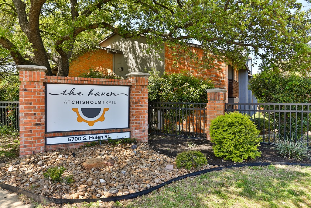 A sign for The Haven Aitchisholm Trail is in front of a house.