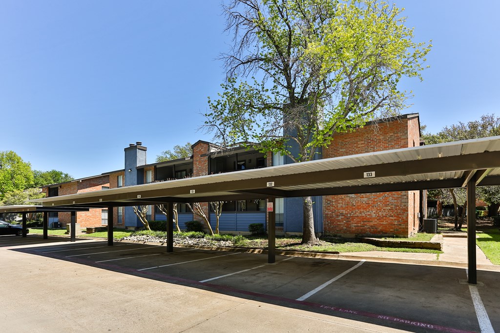 A parking lot with a building in the background.
