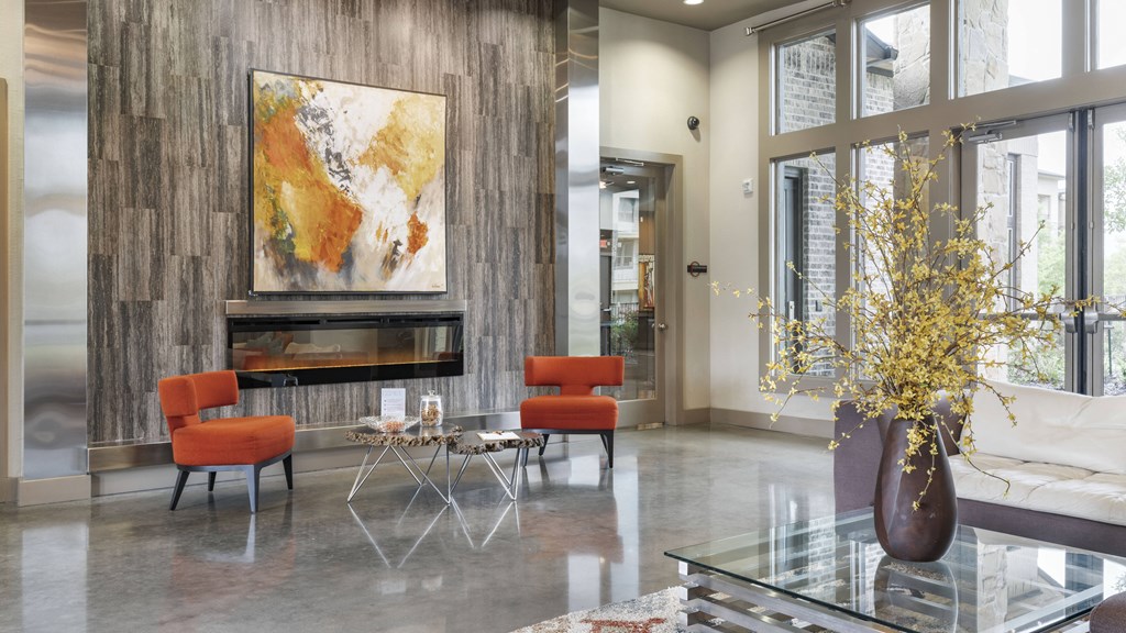a living room with a fireplace and a vase with flowers