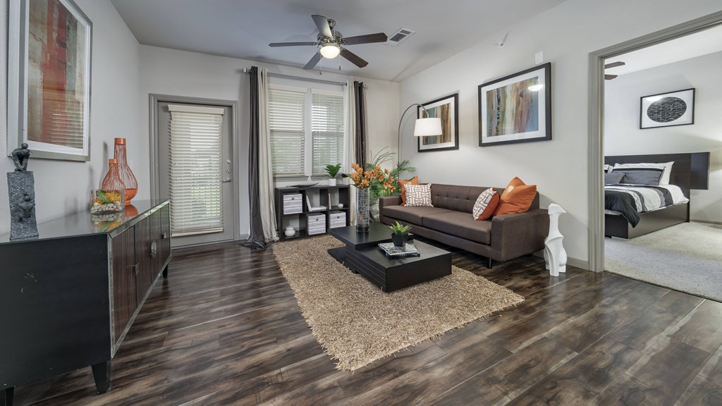 a living room with a couch and a ceiling fan