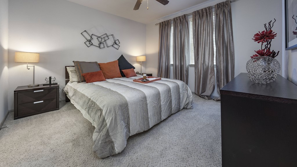 a bedroom with a bed and a dresser and a window