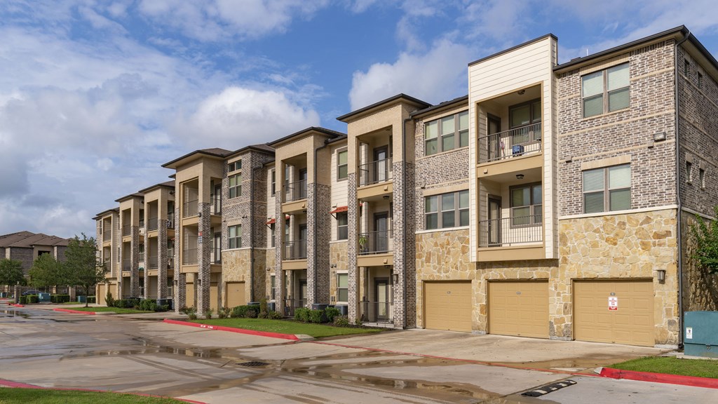 an exterior view of an apartment building on a rainy day