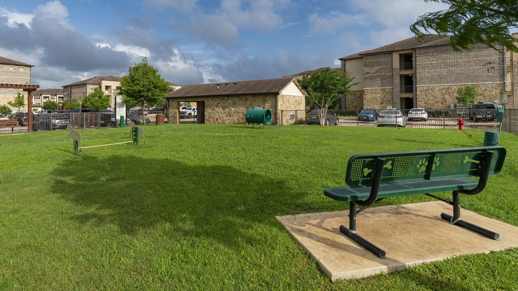 a park bench sitting on top of a grass field