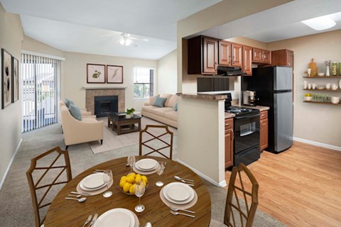A dining room with a table set for two with lemons on the table.