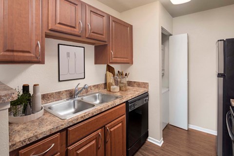 A kitchen with brown cabinets and a white refrigerator.