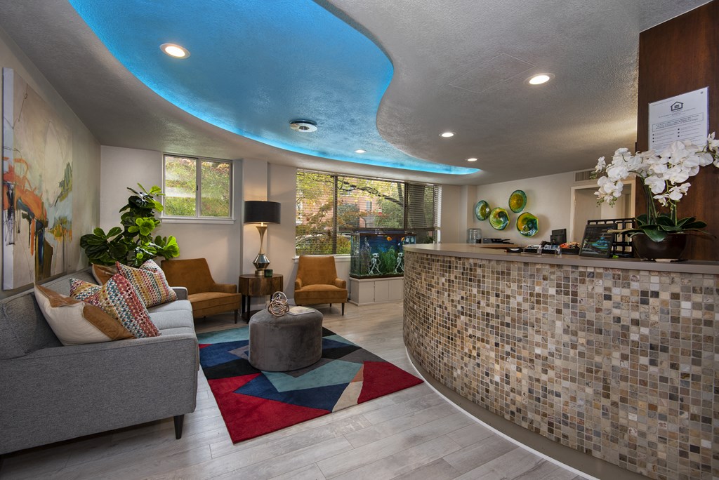 a lobby with a couch chairs and a coffee table