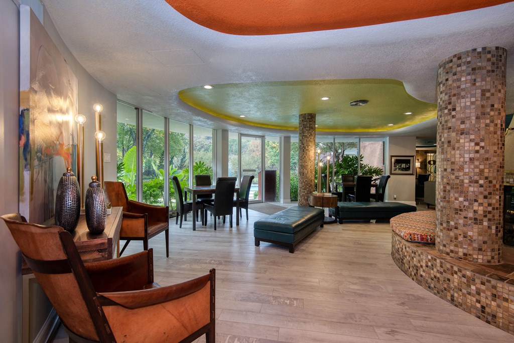 a living room filled with furniture and a large window