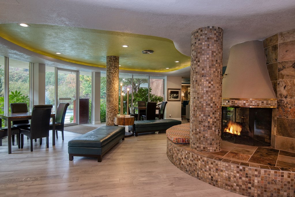 a living room filled with furniture and a large fireplace