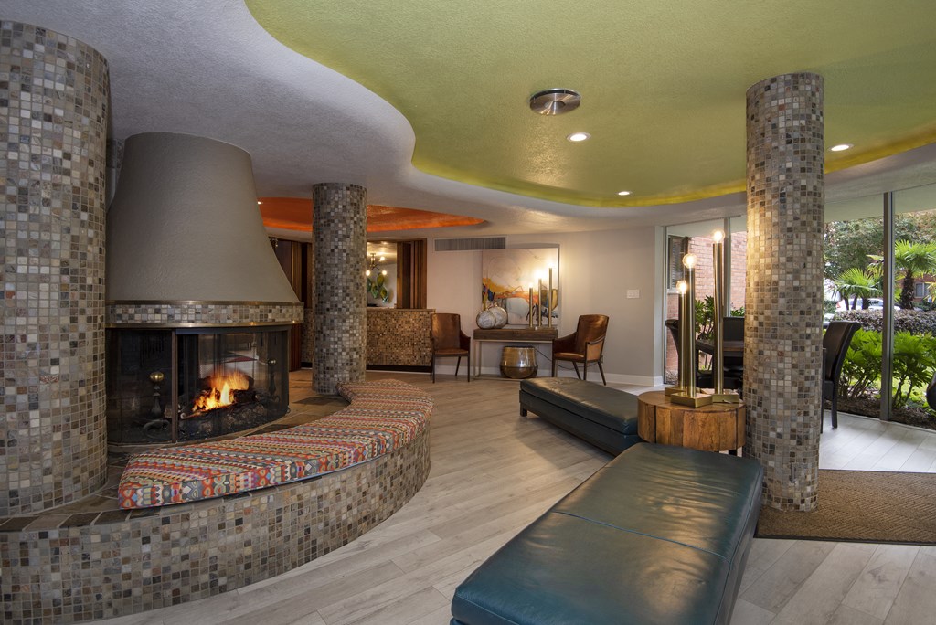 a living room filled with furniture and a large fireplace