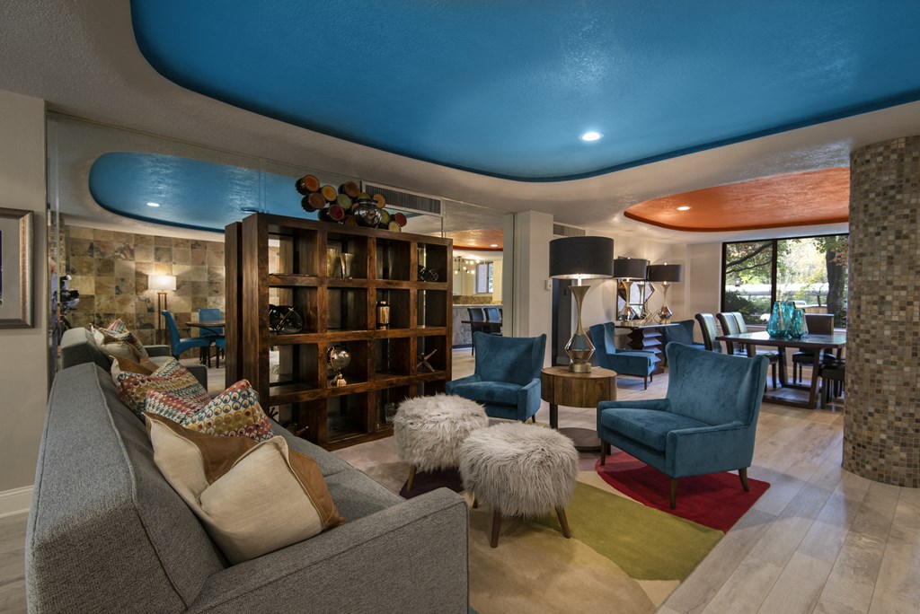 a living room filled with furniture and a large window