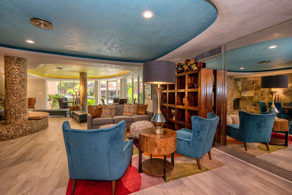 a living room filled with furniture and a large window