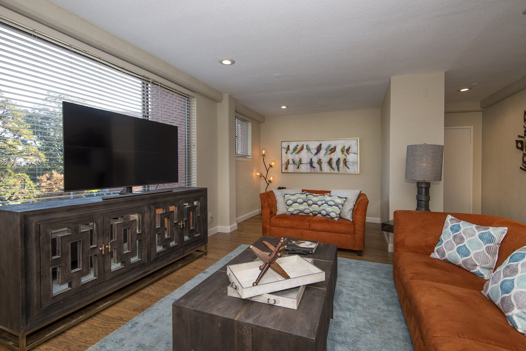 a living room filled with furniture and a flat screen tv