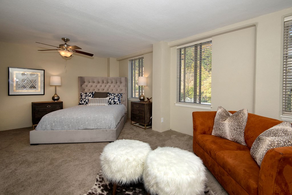 a bedroom with a bed and a ceiling fan