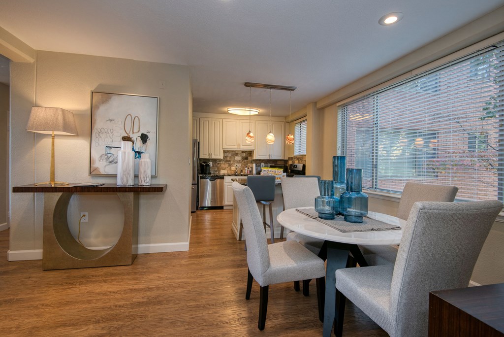 a dining room with a table and chairs