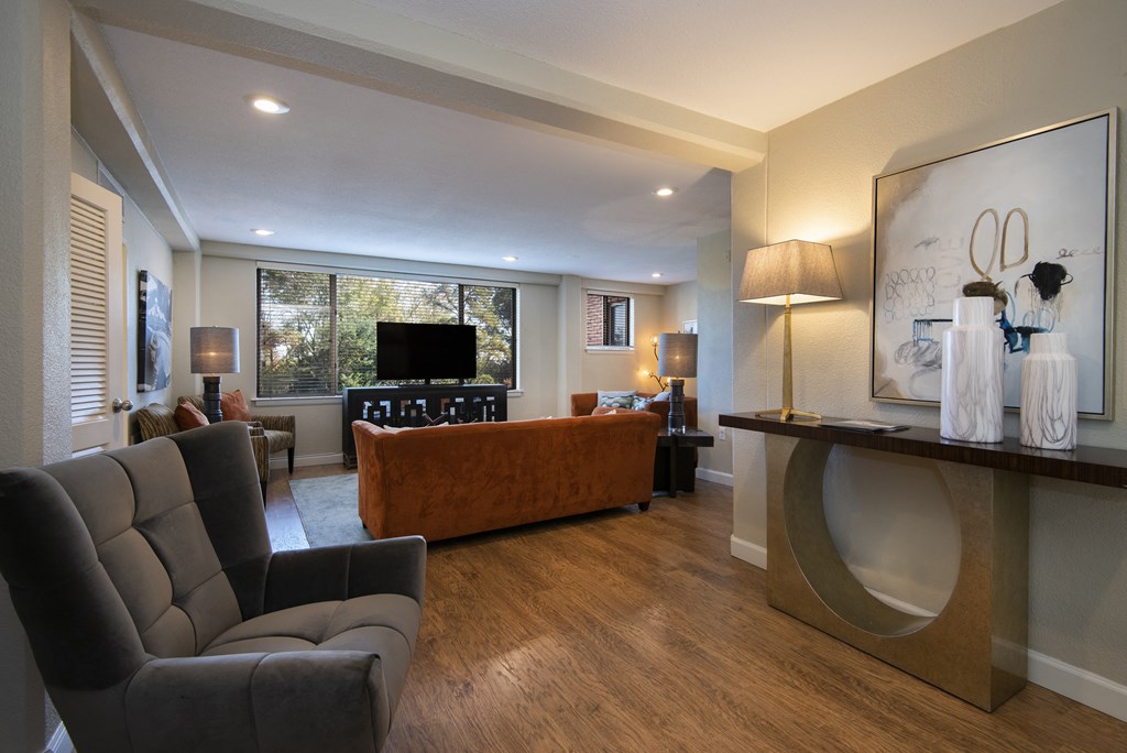 a living room filled with furniture and a flat screen tv