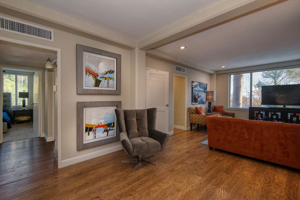 a living room filled with furniture and a large window