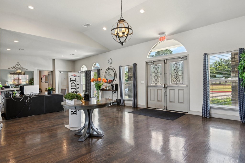 a living room with white walls and a table