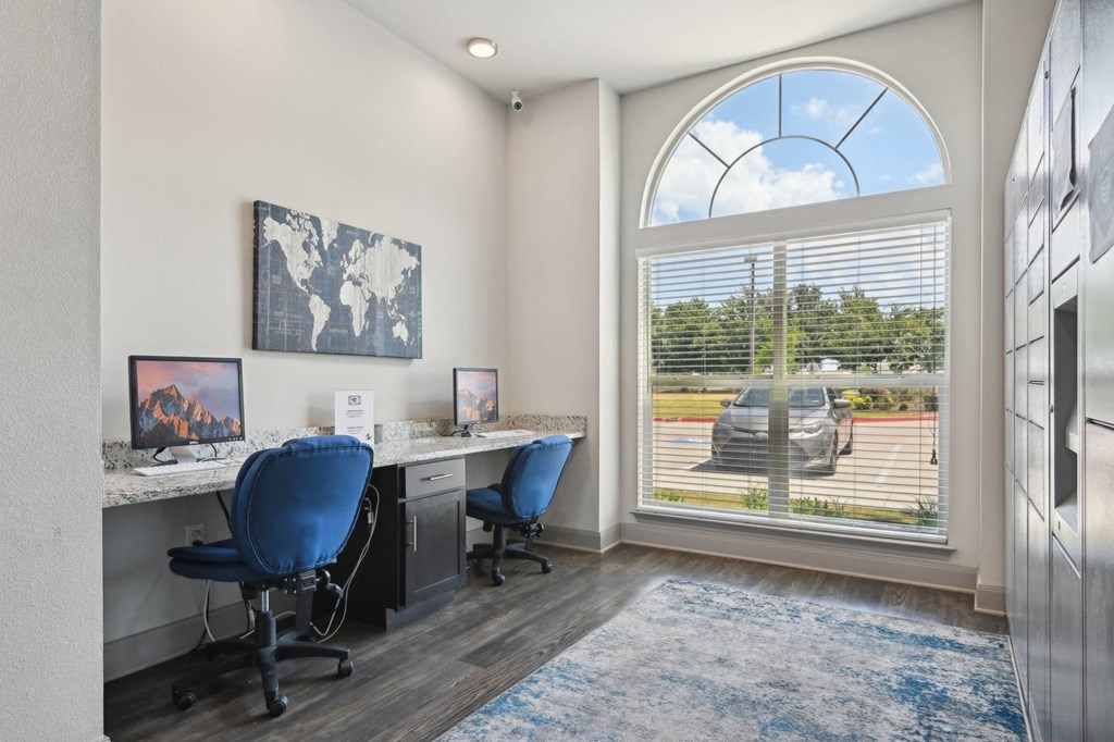 a office with a large window and a desk with two chairs