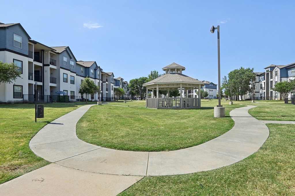 a park with a gazebo in the middle of an apartment complex