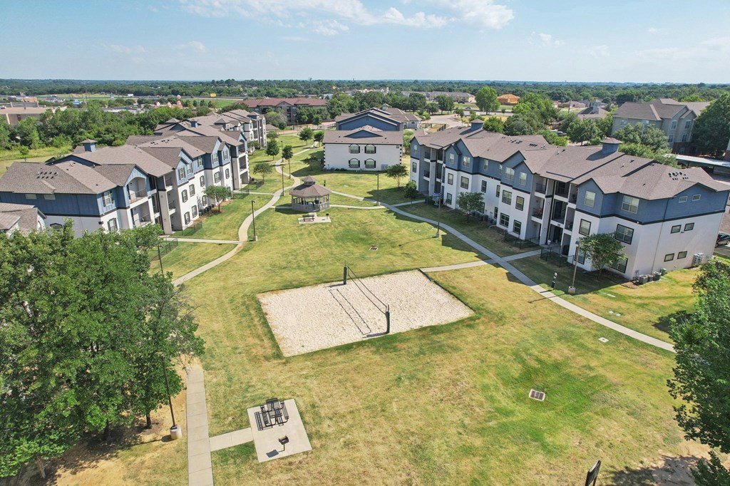 an aerial view of a group of houses in a field