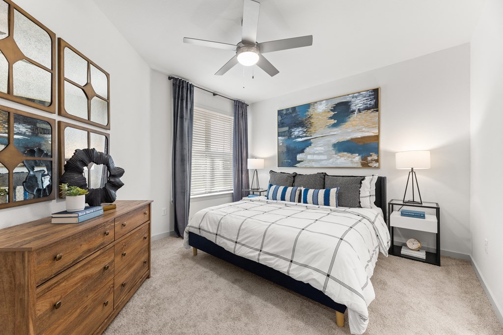 a bedroom with a bed and a ceiling fan