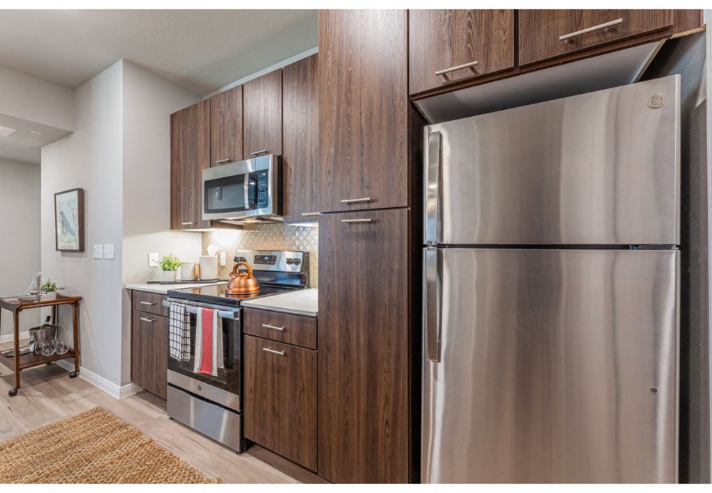 a kitchen with stainless steel appliances and a stainless steel refrigerator