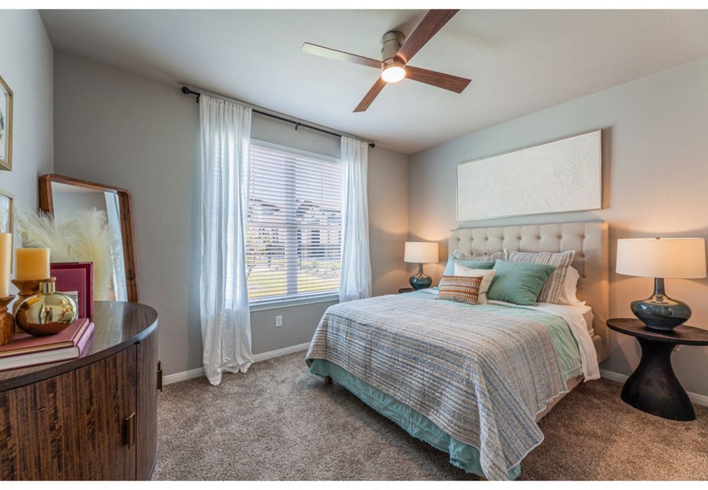 a bedroom with a bed and a ceiling fan