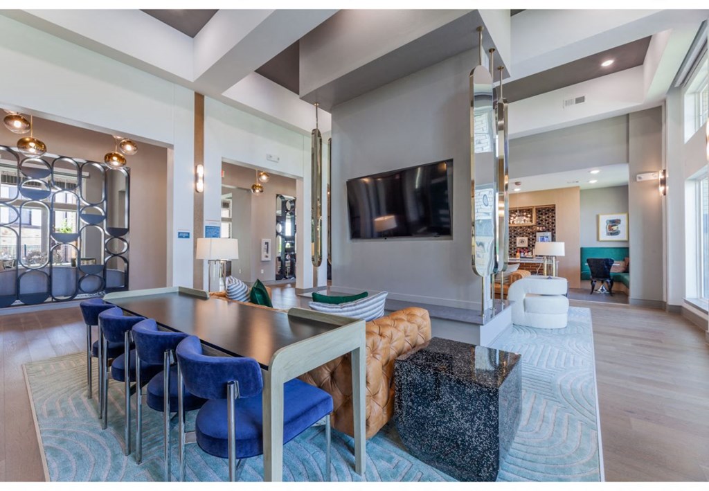 a large living room with a table and chairs and a television