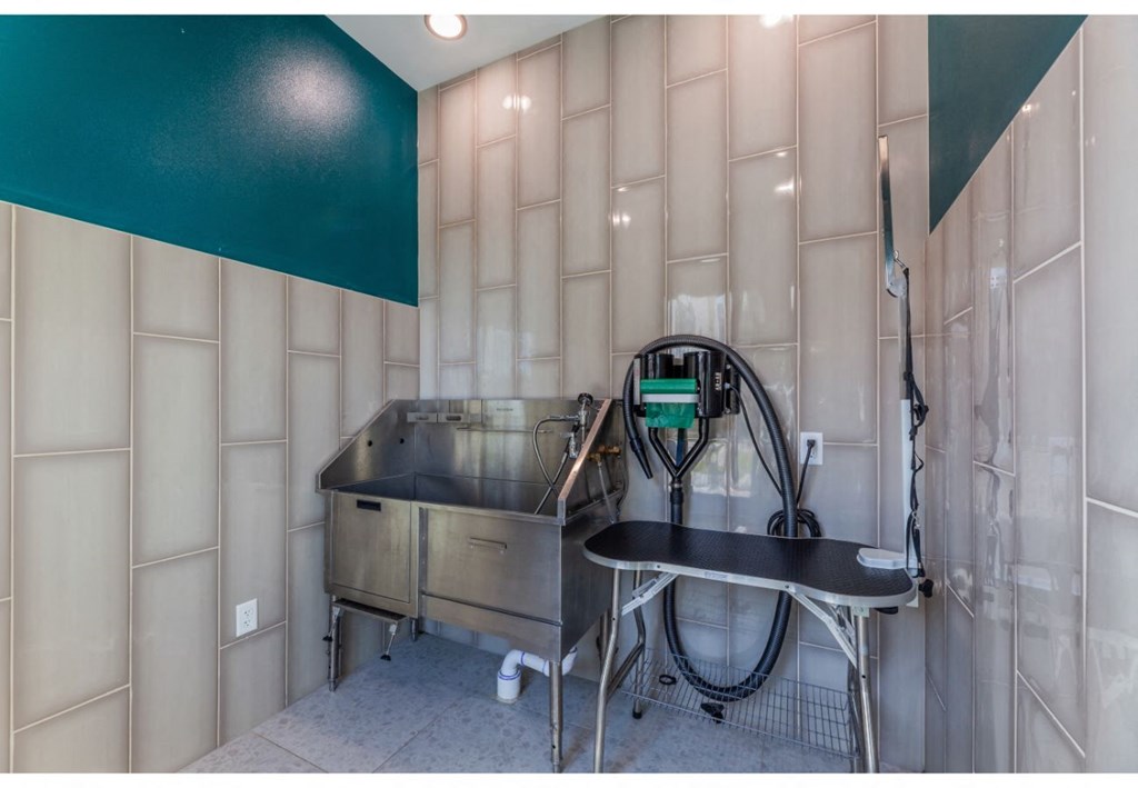 a laundry room with a sink and a tub