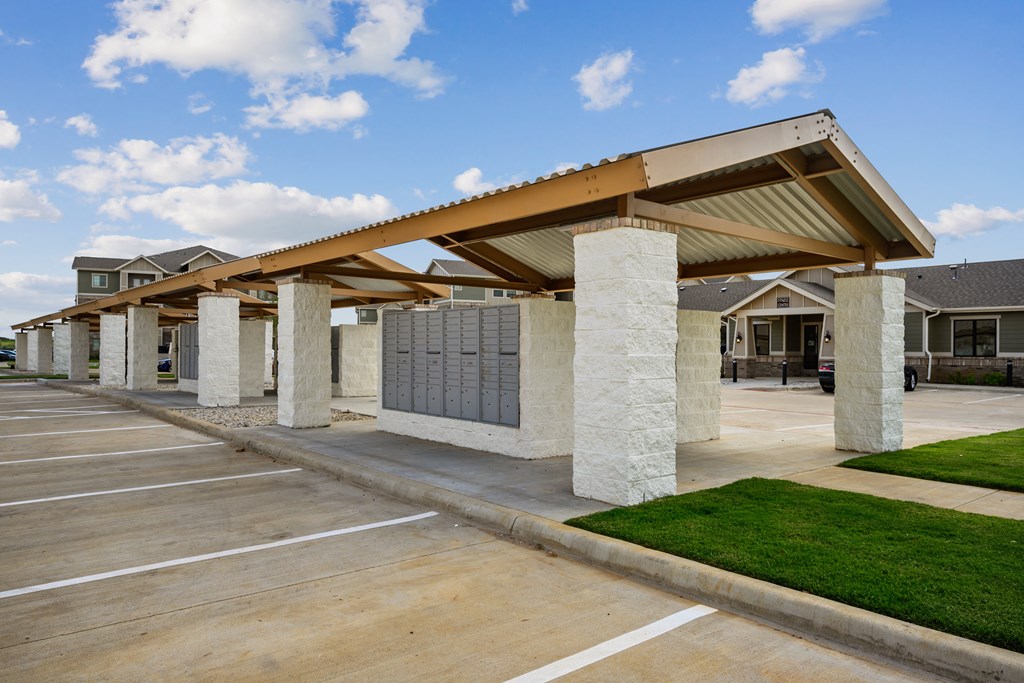 a covered parking lot with houses in the background