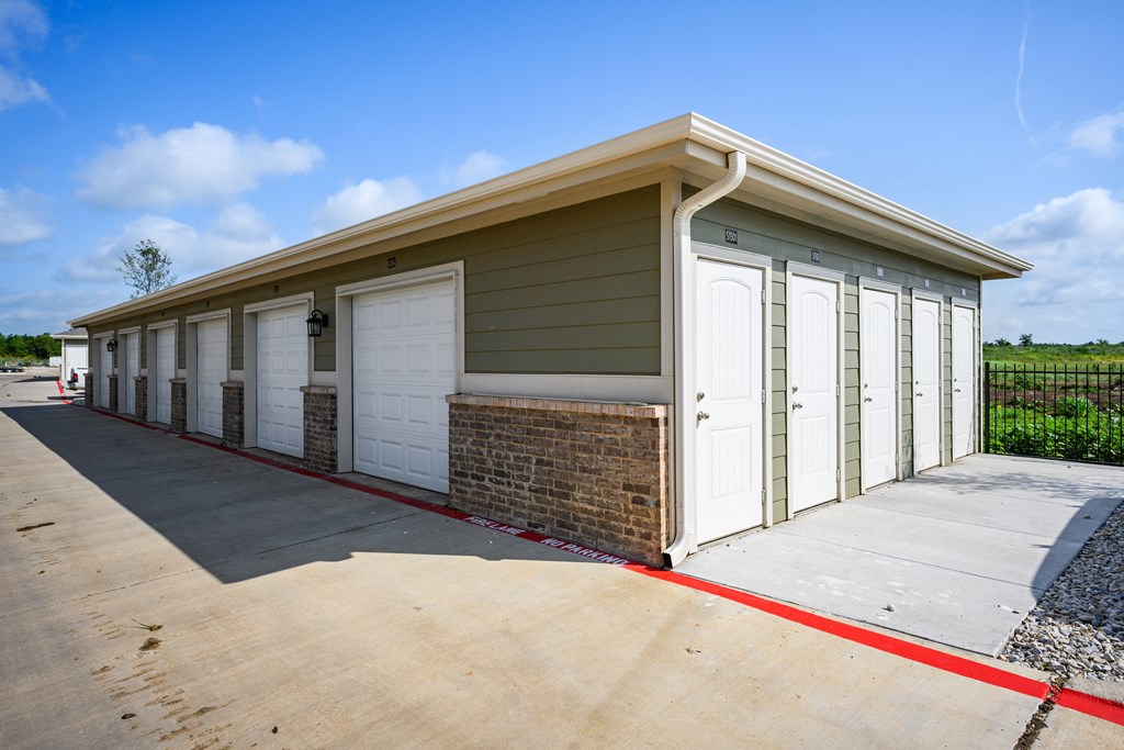 a row of garages with white doors