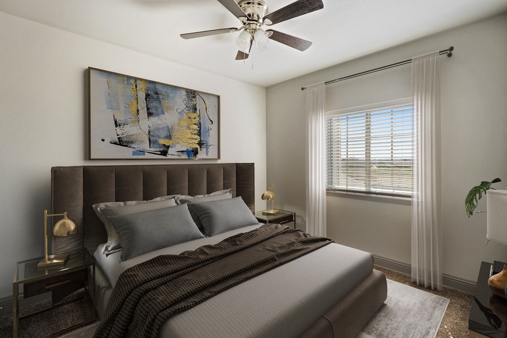 a bedroom with a large bed and a ceiling fan