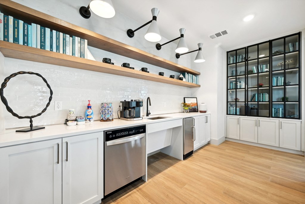 a kitchen with white cabinets and a sink and a dishwasher