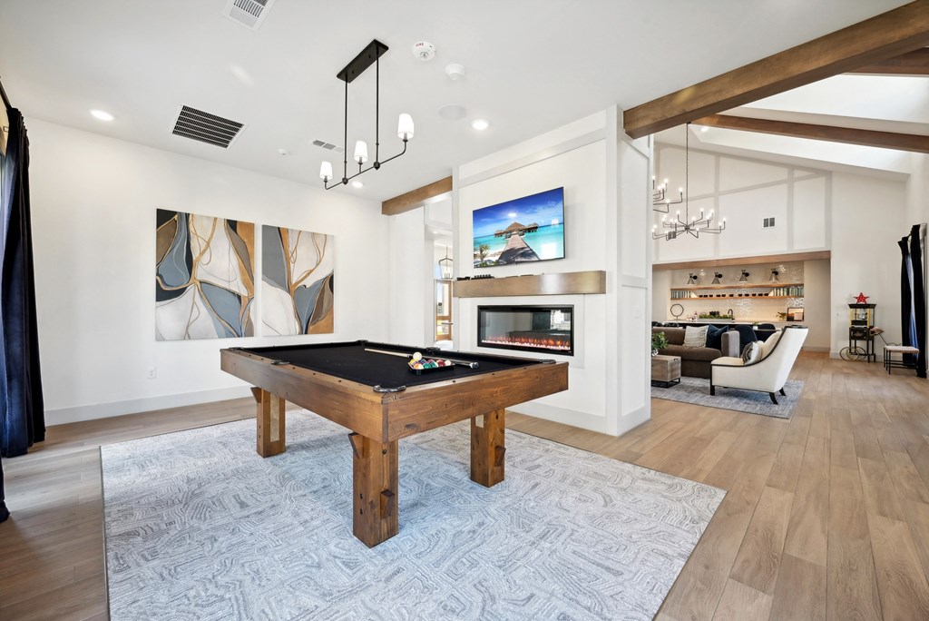 a living room with a pool table and a fireplace