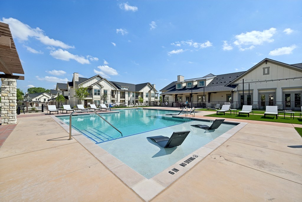 the preserve at ballantyne commons pool with lounge chairs and apartment buildings