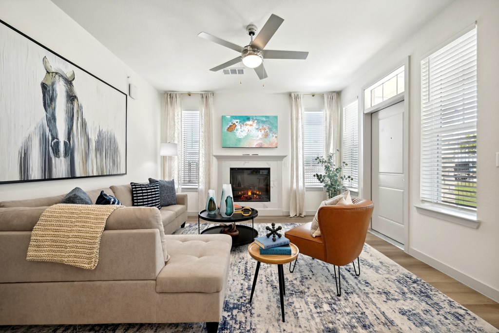 a living room with a couch and a ceiling fan