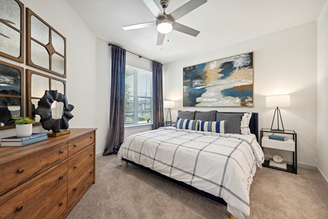 a bedroom with a bed and a ceiling fan
