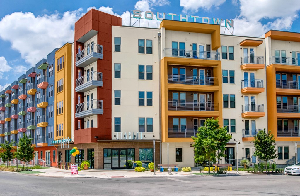 a new apartment building with a street in front of it