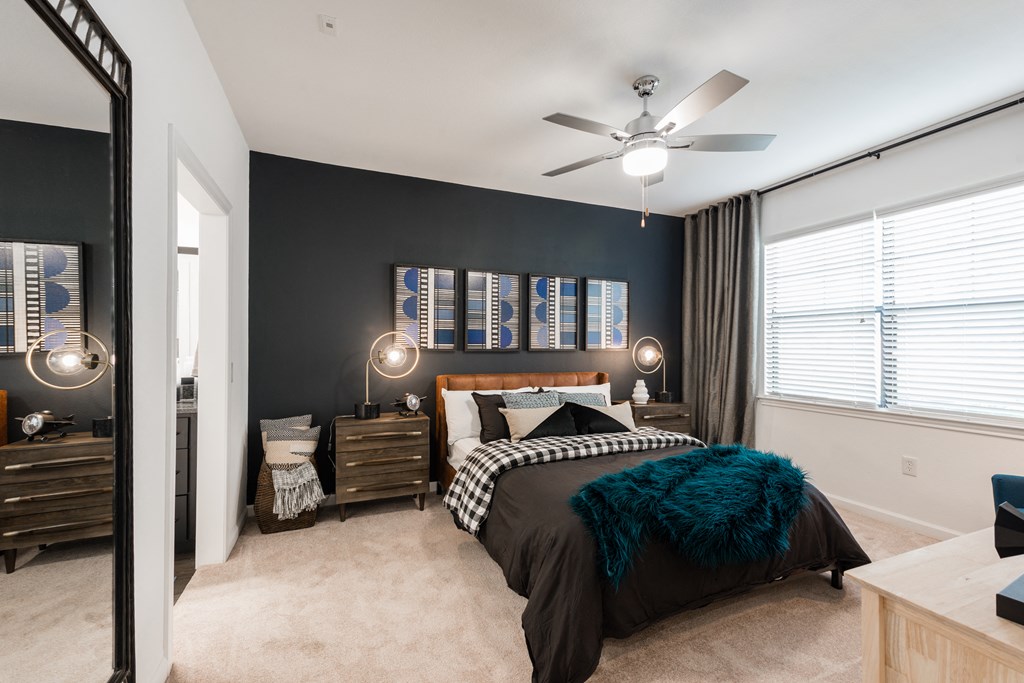 a bedroom with a bed and a ceiling fan