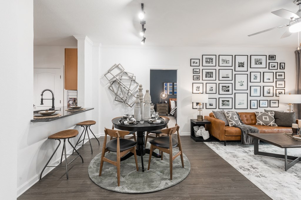 a dining area with a round table and four chairs